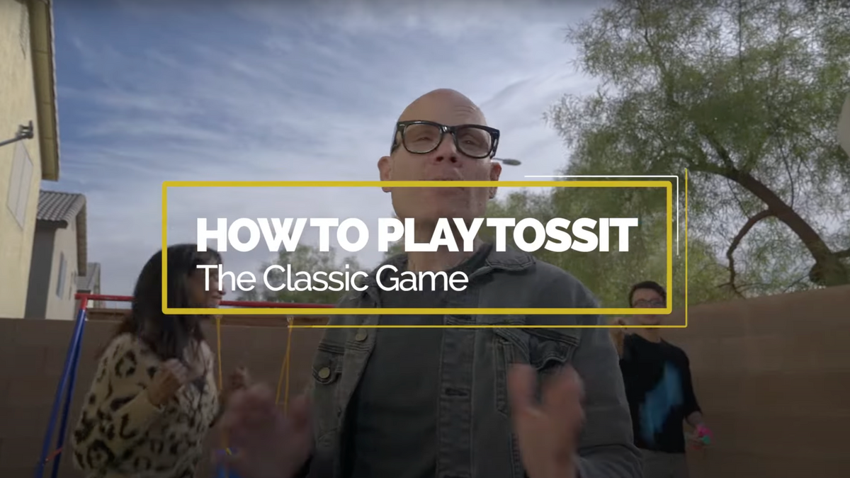 Tossit players tossing suction-cup darts at a board