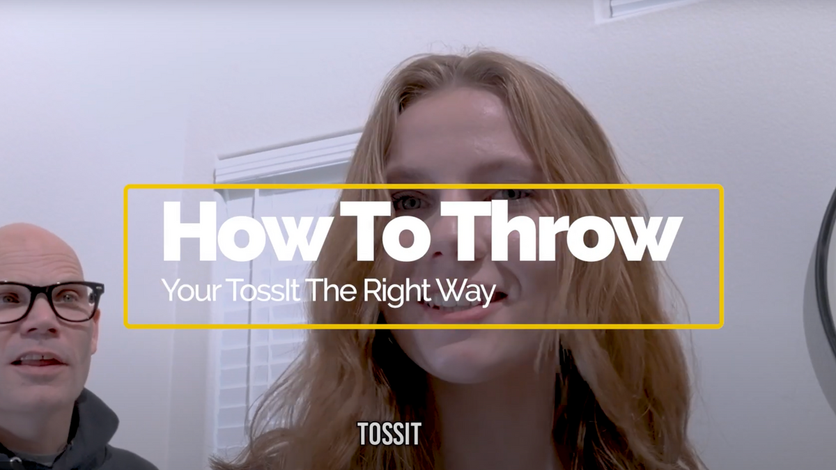 Tossit players demonstrating how to throw a suction-cup dart