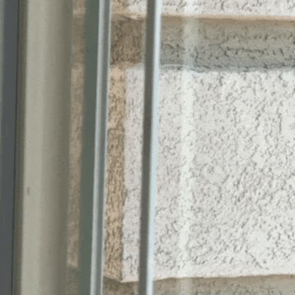 A dart sticking to a window